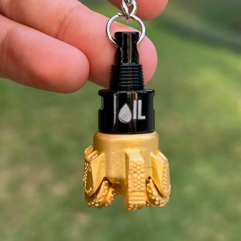 Oil drill bit keychain black and gold