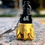 Oil drill bit keychain black and gold