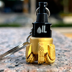 Oil drill bit keychain black and gold