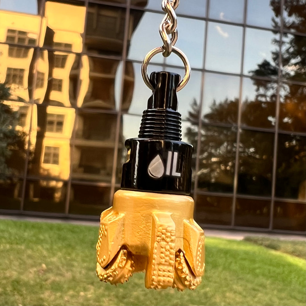 Oil drill bit keychain black and gold