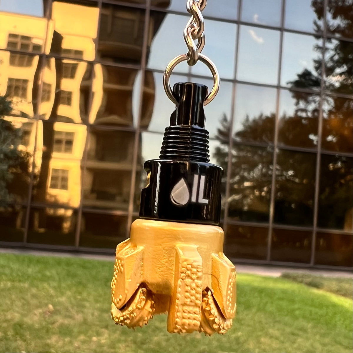Oil drill bit keychain black and gold