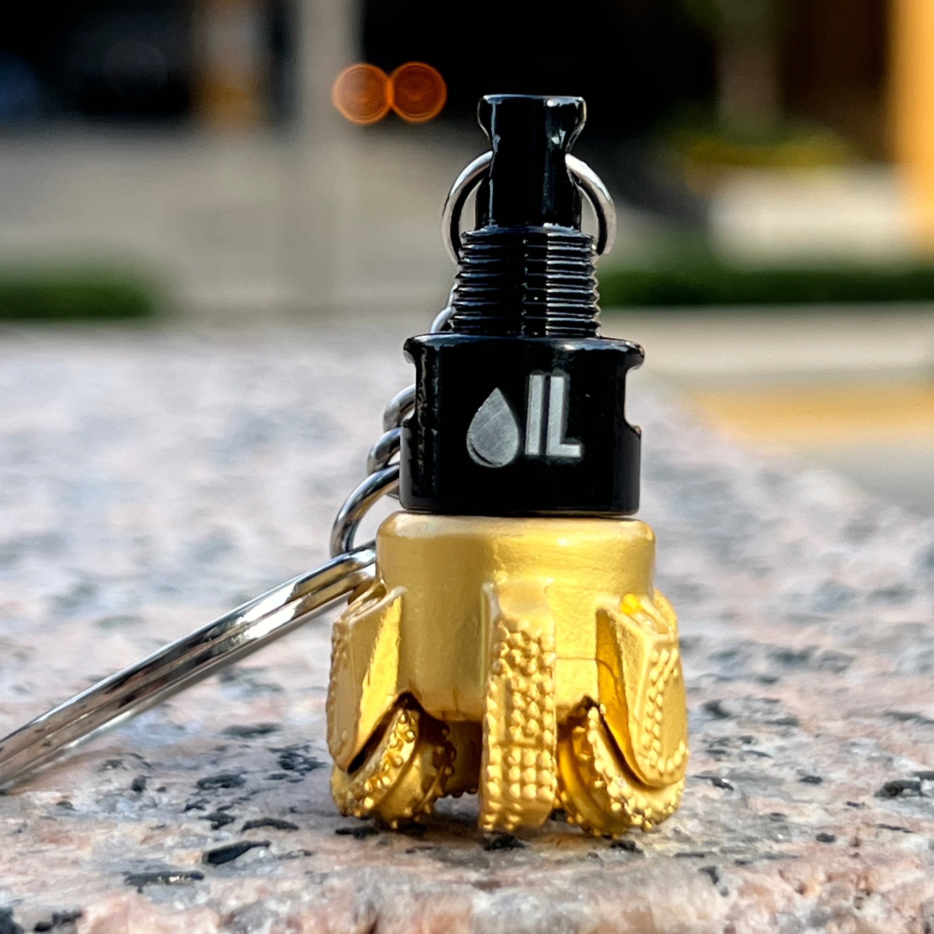 Oil drill bit keychain black and gold